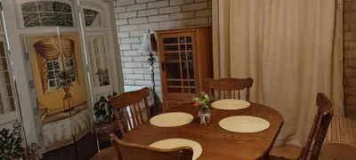 a dining room with a wooden table and chairs at Rustic Rooms by Kings Canyon & Sequoia National Parks in Squaw Valley
