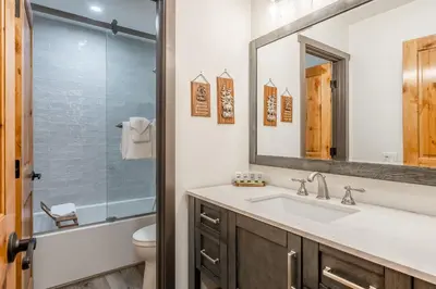 a bathroom with a sink and a toilet and a mirror at Horizons IV #156 New Luxurious Listing! Fully Remodeled 2 Bedroom Plus Loft 3 Full Bathroom Sleeps 8 in Mammoth Lakes
