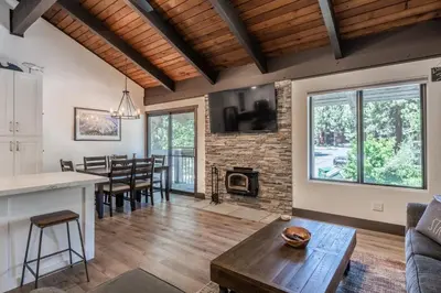 a kitchen and living room with a fireplace and a table at Horizons IV #156 New Luxurious Listing! Fully Remodeled 2 Bedroom Plus Loft 3 Full Bathroom Sleeps 8 in Mammoth Lakes