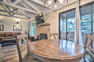 a dining room with a table and a fireplace at Elegant Mountain-View Condo Less Than 1 Mi to Lifts! in Mammoth Lakes