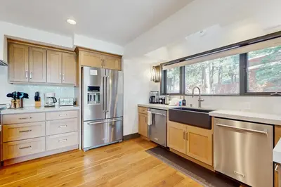 a kitchen with stainless steel appliances and wooden cabinets at Bennett Flat Adventure in Truckee