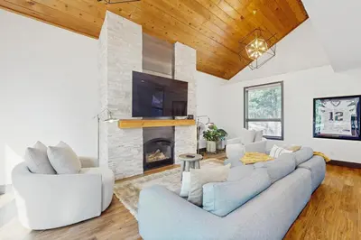 a living room with a couch and a fireplace at Bennett Flat Adventure in Truckee