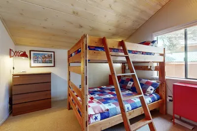 a bedroom with two bunk beds and a desk at Falcon Point Pines in Truckee