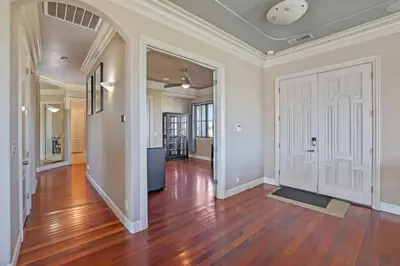 an empty living room with wood floors and a white door at 4BR LUXURY ENTERTAINMENT OASIS in Tracy