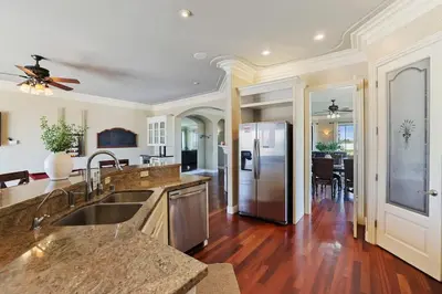 a kitchen with a sink and a refrigerator at 4BR LUXURY ENTERTAINMENT OASIS in Tracy