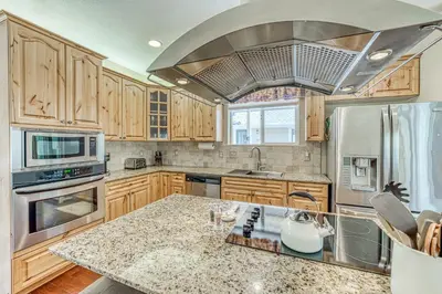a kitchen with wooden cabinets and a stainless steel appliance at Wooded Bliss in Mariposa