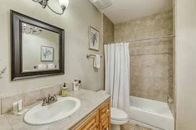 a bathroom with a sink and a toilet and a shower at Wooded Bliss in Mariposa