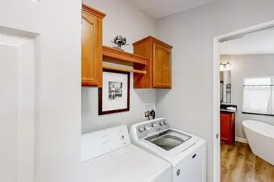 a laundry room with a washing machine and a sink at Out in the Wild in Oakhurst