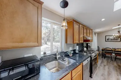a kitchen with a sink and a stove at Out in the Wild in Oakhurst