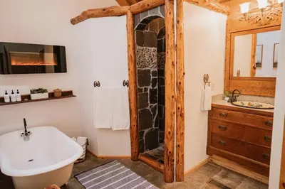 a bathroom with a tub and a sink at Scenic View Timber Lodge HotTub by Casa Oso in Mariposa