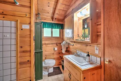 a bathroom with a toilet and a sink at Comfortable Mi-Wuk Village Cabin Hike and Ski! in Mi-Wuk Village