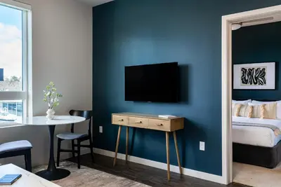 a bedroom with a bed and a television on a wall at Kasa Archive Reno-Tahoe in Reno