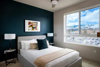 a bedroom with a bed and a large window at Kasa Archive Reno-Tahoe in Reno