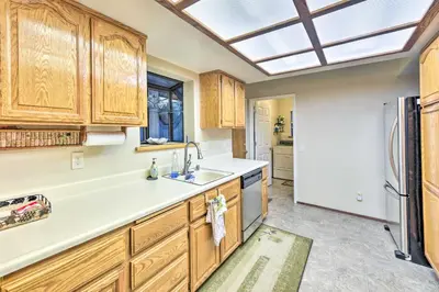 a kitchen with wooden cabinets and a skylight at Near Fishing and Hiking Pioneer Cabin with Decks in Pioneer