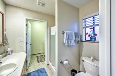 a bathroom with a toilet and a sink and a window at Near Fishing and Hiking Pioneer Cabin with Decks in Pioneer