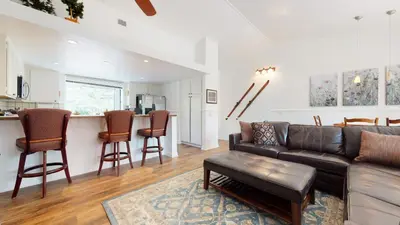 a living room with a couch and a kitchen at Forest Creek #15 condo in Mammoth Lakes