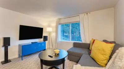 a living room with a couch and a tv at Golden Summit by AvantStay Stunning Secluded Cabin w Access to Tahoe Donner in Truckee