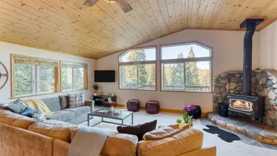 a living room with a couch and a fireplace at Golden Summit by AvantStay Stunning Secluded Cabin w Access to Tahoe Donner in Truckee