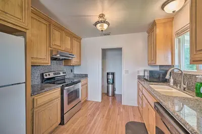 a kitchen with wooden cabinets and a counter top at Waterfront Bethel Island Home with Dock and Slip in Bethel Island