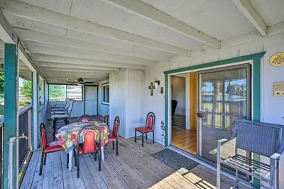 a porch of a house with a table and chairs at Waterfront Bethel Island Home with Dock and Slip in Bethel Island