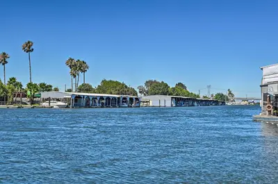 a large body of water with buildings and palm trees at Waterfront Bethel Island Home with Dock and Slip in Bethel Island