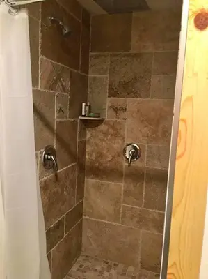a shower with a glass door with a tiled shower at Modern Cabin Get Away - close to APPLE HILL in Pollock Pines