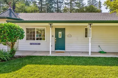 a house with a green door and a yard at Acorn House - Charming house in green heaven with pool table with lovely backyard in Oakhurst