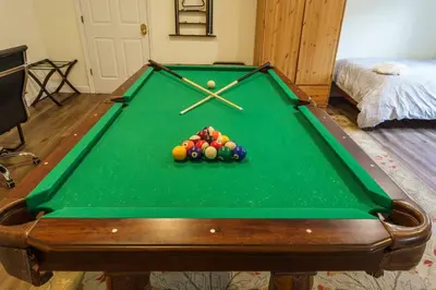 a pool table with balls on it in a room at Acorn House - Charming house in green heaven with pool table with lovely backyard in Oakhurst