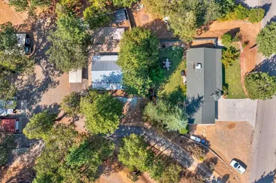 an overhead view of a building with trees and cars at Acorn House - Charming house in green heaven with pool table with lovely backyard in Oakhurst