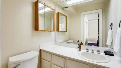a bathroom with a sink and a mirror at Marillac by AvantStay Gorgeous Ski Cabin w Balcony Patio in Olympic Valley