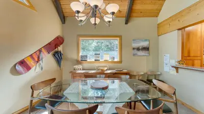 a dining room with a glass table and chairs at Ember by AvantStay Majestic Entertainers Home w Pine Tree Views Close to Meeks Bay in Tahoma Meadows
