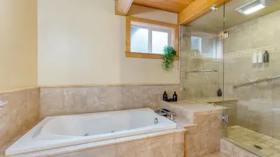 a large bathroom with a tub and a shower at Ember by AvantStay Majestic Entertainers Home w Pine Tree Views Close to Meeks Bay in Tahoma Meadows