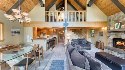 an open living room with a fireplace and a dining room at Ember by AvantStay Majestic Entertainers Home w Pine Tree Views Close to Meeks Bay in Tahoma Meadows
