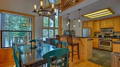 a kitchen with a table and chairs in a room at Black Bear by AvantStay Spacious Viking Lodge in Tahoe Donner w Game Room Hot Tub in Truckee