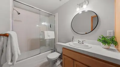a bathroom with a toilet and a sink and a mirror at Moosetrack by AvantStay Cozy Cabin w Hot Tub In The Heart of Tahoe Donner in Truckee