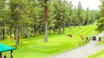 a group of people playing golf on a golf course at Moosetrack by AvantStay Cozy Cabin w Hot Tub In The Heart of Tahoe Donner in Truckee