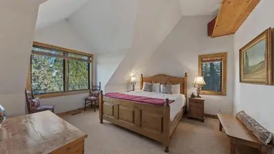 a bedroom with a bed and a desk and windows at Ellis Peak by AvantStay Beautiful McKinney Cabin w Filtered Lake Views in Homewood