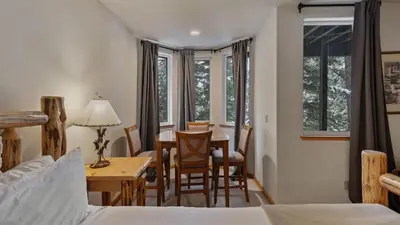 a room with a table and chairs and a dining room at Sparrow by AvantStay Modern Mountain Retreat w Hot Tub Pool Table Games in Truckee