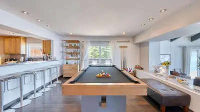 a room with a pool table in a kitchen at Lakeview by AvantStay Private Waterfront Cabin on Lake Tahoe w Hot Tub Views in Tahoe Vista