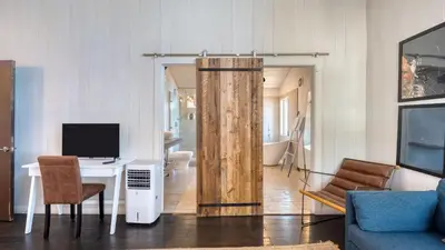 a living room with a desk with a computer and a television at Lakeview by AvantStay Private Waterfront Cabin on Lake Tahoe w Hot Tub Views in Tahoe Vista