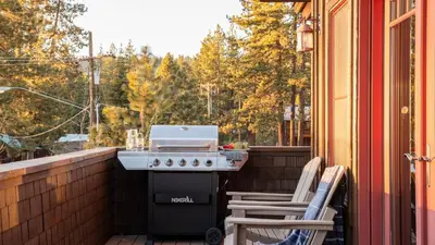 a grill on a screened in porch with two chairs at Lakefront Home in Kings Beach w Views • Prime Location Atkinson by Avantstay in Tahoe Vista