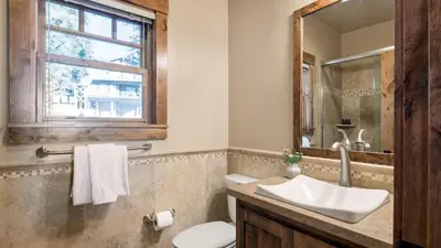 a bathroom with a sink and a toilet and a window at Lakefront Home in Kings Beach w Views • Prime Location Atkinson by Avantstay in Tahoe Vista