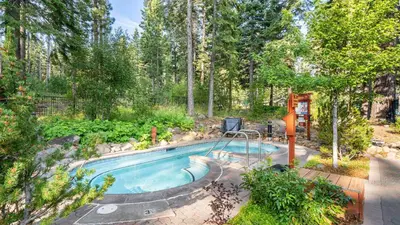 a swimming pool in the middle of a yard with trees at Ski-InSki-Out Access to Northstar Resort Near Truckee Sierra by AvantStay in Kingswood Estates