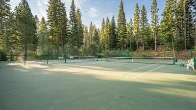 a tennis court with two tennis rackets on it at Ski-InSki-Out Access to Northstar Resort Near Truckee Sierra by AvantStay in Kingswood Estates
