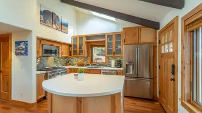 a large kitchen with a white island in the middle at Henderson by AvantStay Lake View Walk to Beach Garwoods More in Carnelian Bay