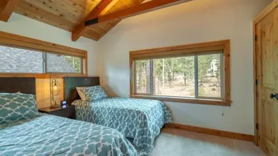 a bedroom with two beds and a window at Henderson by AvantStay Lake View Walk to Beach Garwoods More in Carnelian Bay