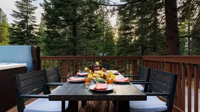 a table on a deck with food on it at Wolfe by AvantStay 5mins NorthStar Fireplace 2 Private Decks in Ponderosa Fairway Estates