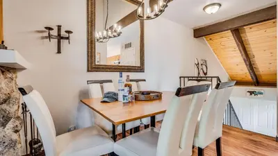 a dining room with a wooden table and chairs at Pinegrove by AvantStay Beautiful Villas Condo just outside Tahoe City in Dollar Point