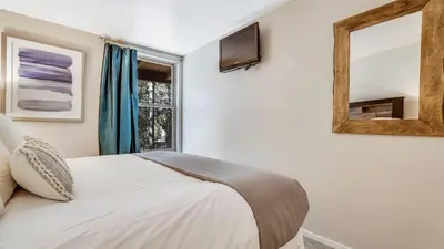 a bedroom with a bed and a mirror and a window at Pinegrove by AvantStay Beautiful Villas Condo just outside Tahoe City in Dollar Point