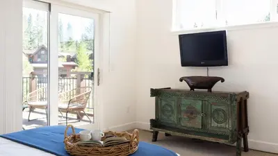 a living room with a tv and a basket of mugs at Quartz by AvantStay Stunning Home In Truckee w Views in Ponderosa Fairway Estates
